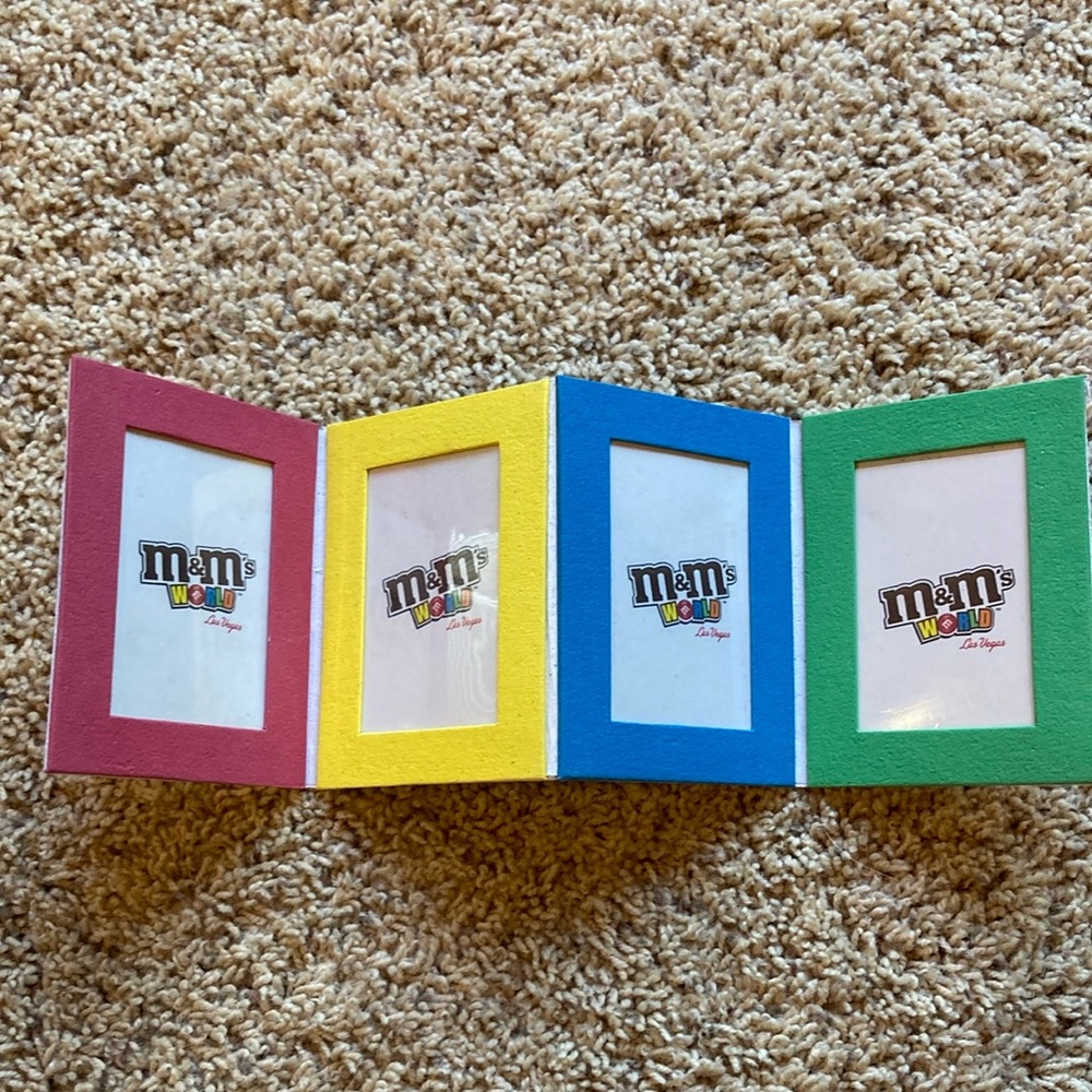 M&M'S World Logo Graphic with Red, Yellow, Blue, Green, Orange, Brown Accents